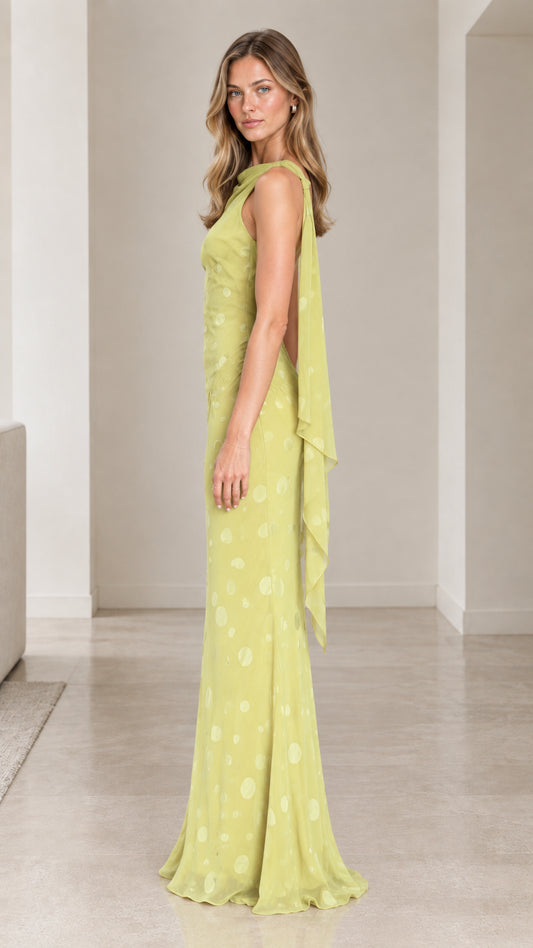 Side profile of chartreuse draped back evening gown
