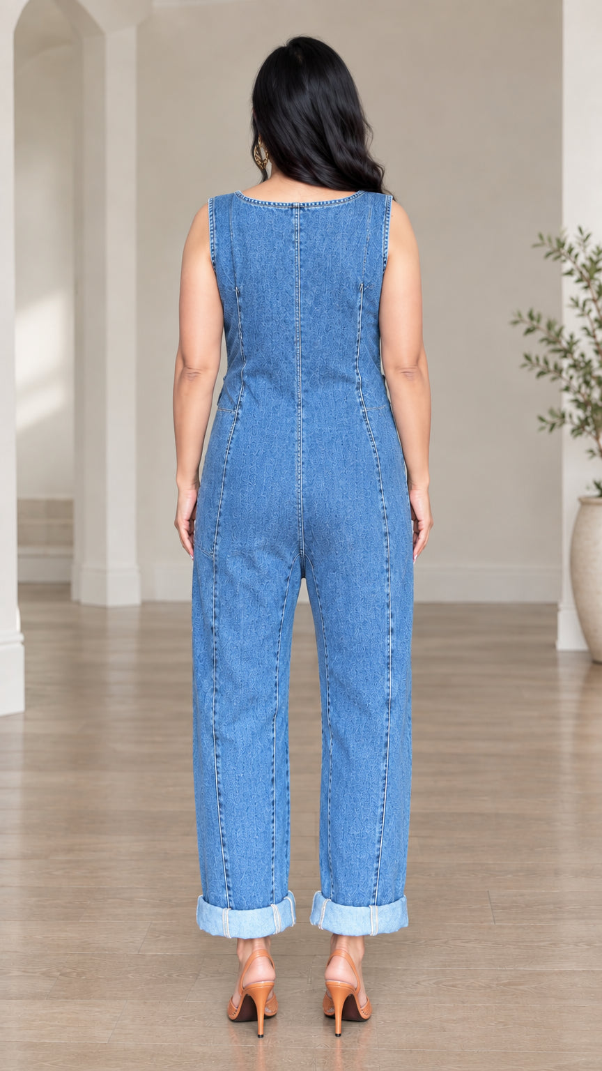 Back view of model wearing denim blue sleeveless casual jumpsuit