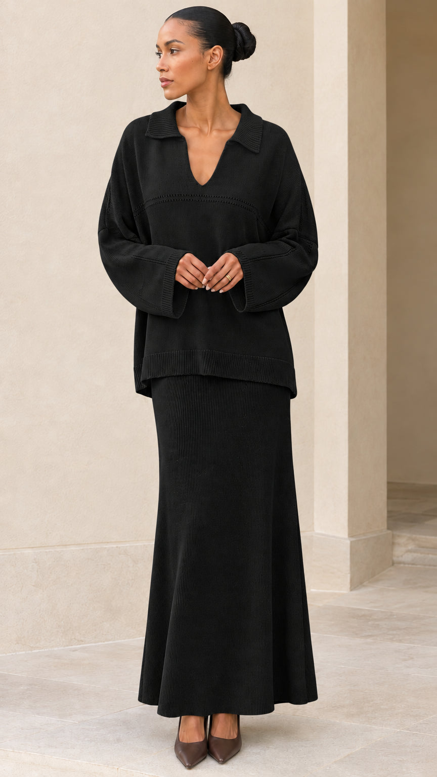 Front view of model wearing Black knit polo sweater and maxi skirt set