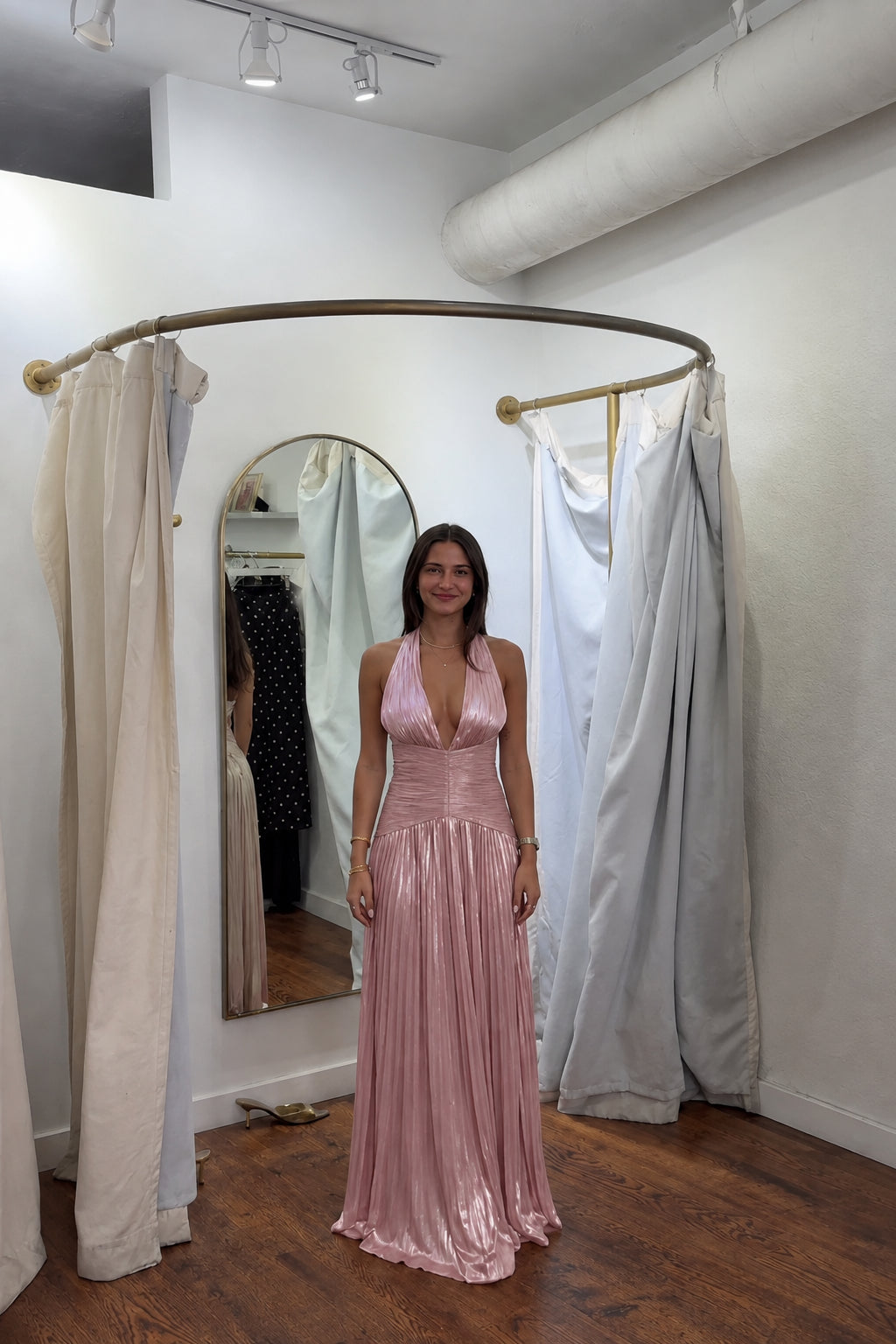Front view of model wearing rose pink metallic pleated halter maxi dress