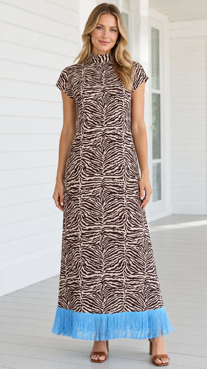 Front view of model wearing brown zebra print mock neck maxi dress with sky blue fringe hem