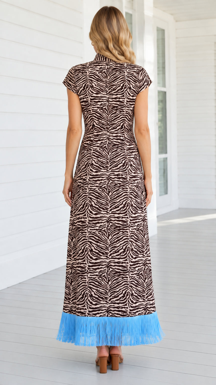 Back view of brown zebra print mock neck maxi dress showing back zipper and fit