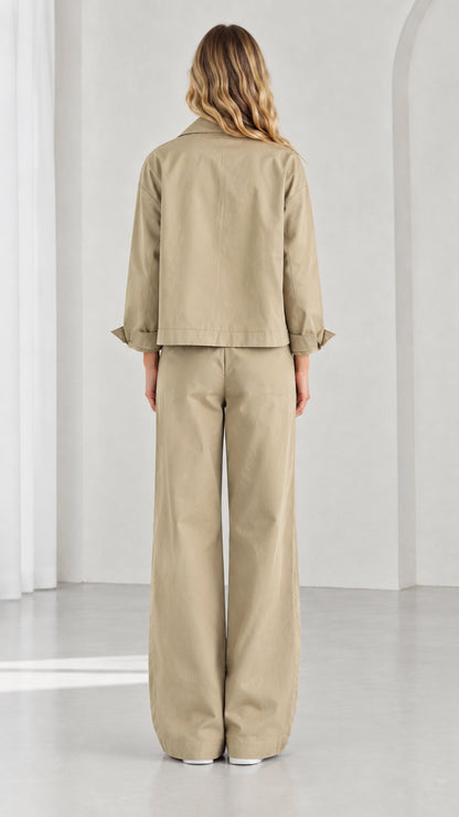 Back view of women's khaki two-piece utility jacket and wide-leg pants set