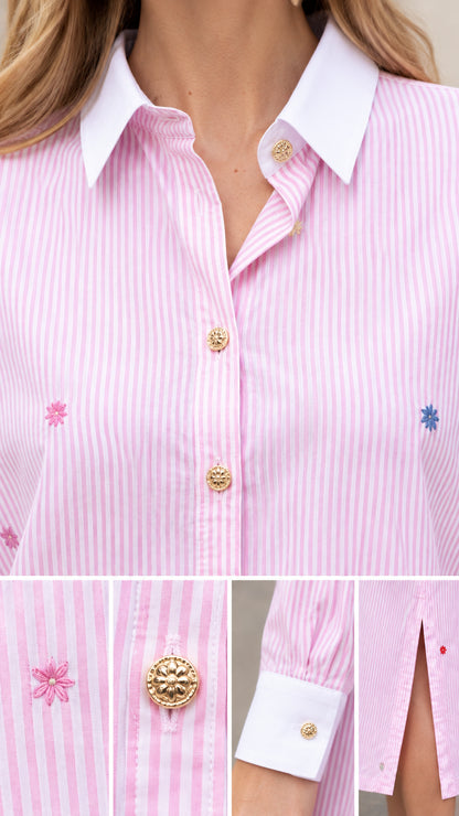 Close-up details of embroidered motifs, gold-tone button, and contrast collar