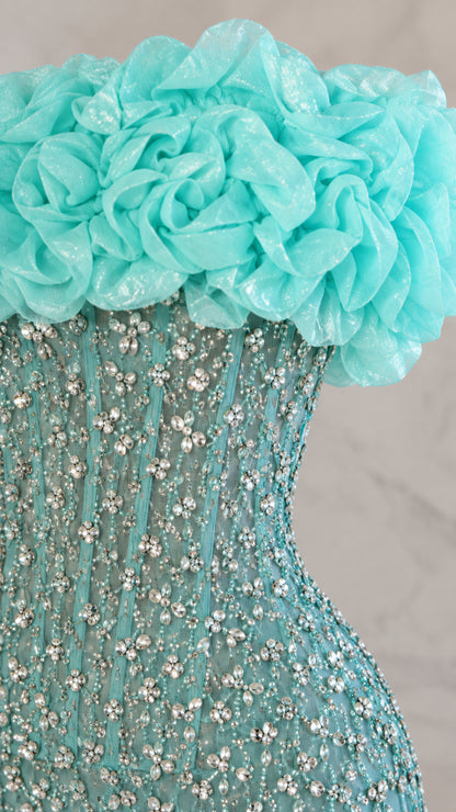Close-up detail of aqua blue 3D fabric rosettes and intricate crystal beading