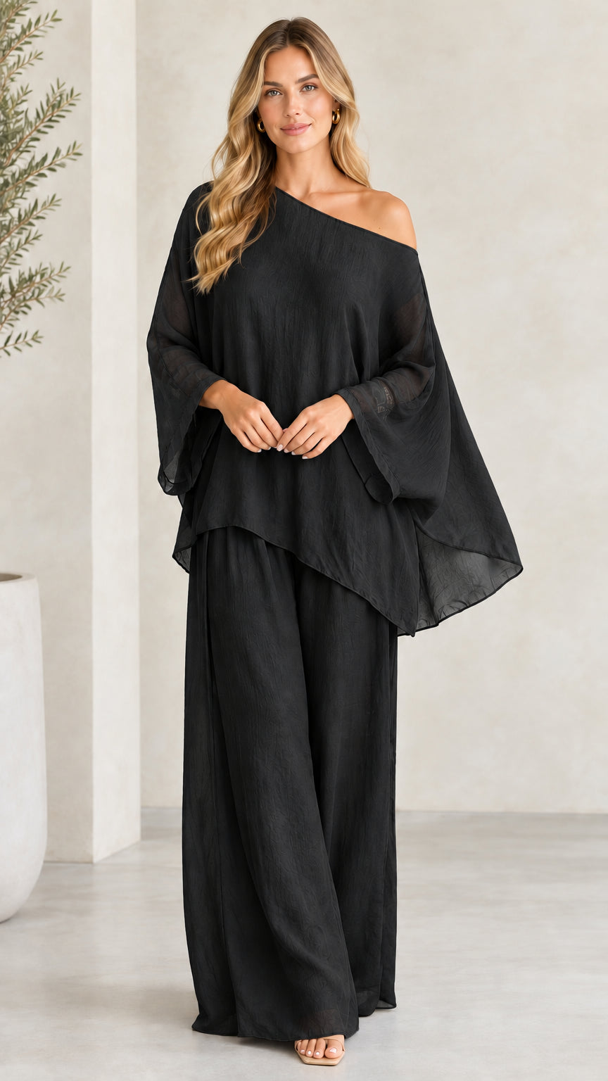 Front view of woman wearing Black one-shoulder asymmetric wide-leg pant set