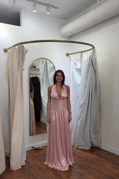 Front view of model wearing rose pink metallic pleated halter maxi dress