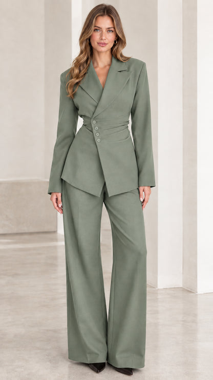 Front view of woman wearing sage green tailored two-piece pantsuit