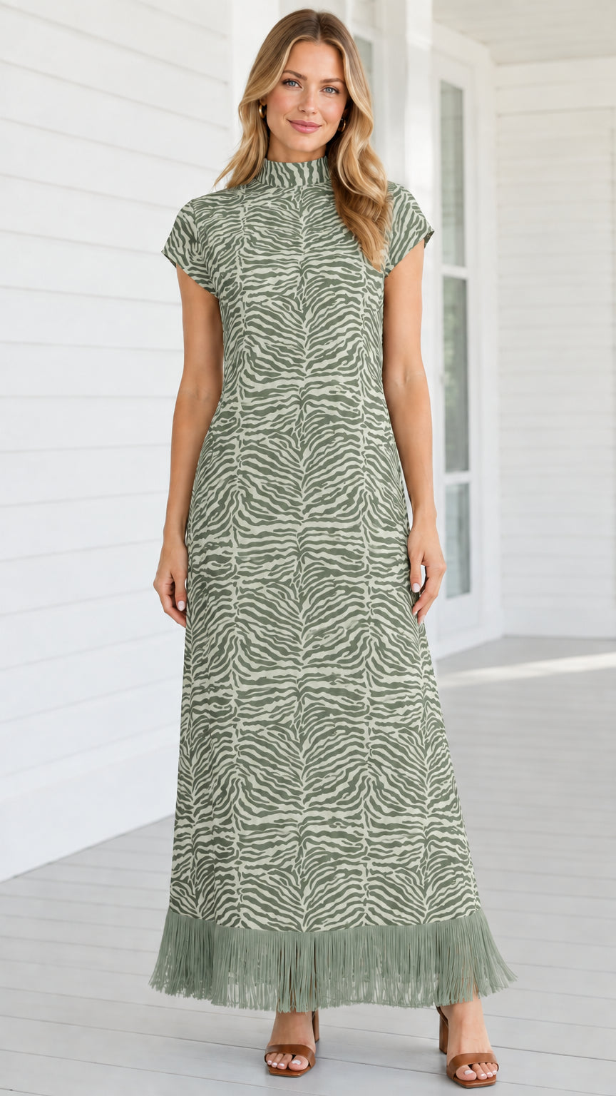 Model wearing sage green zebra print mock neck maxi dress with matching fringe hem