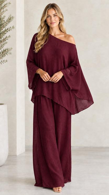 Front view of woman wearing Burgundy asymmetric top and wide-leg trousers set