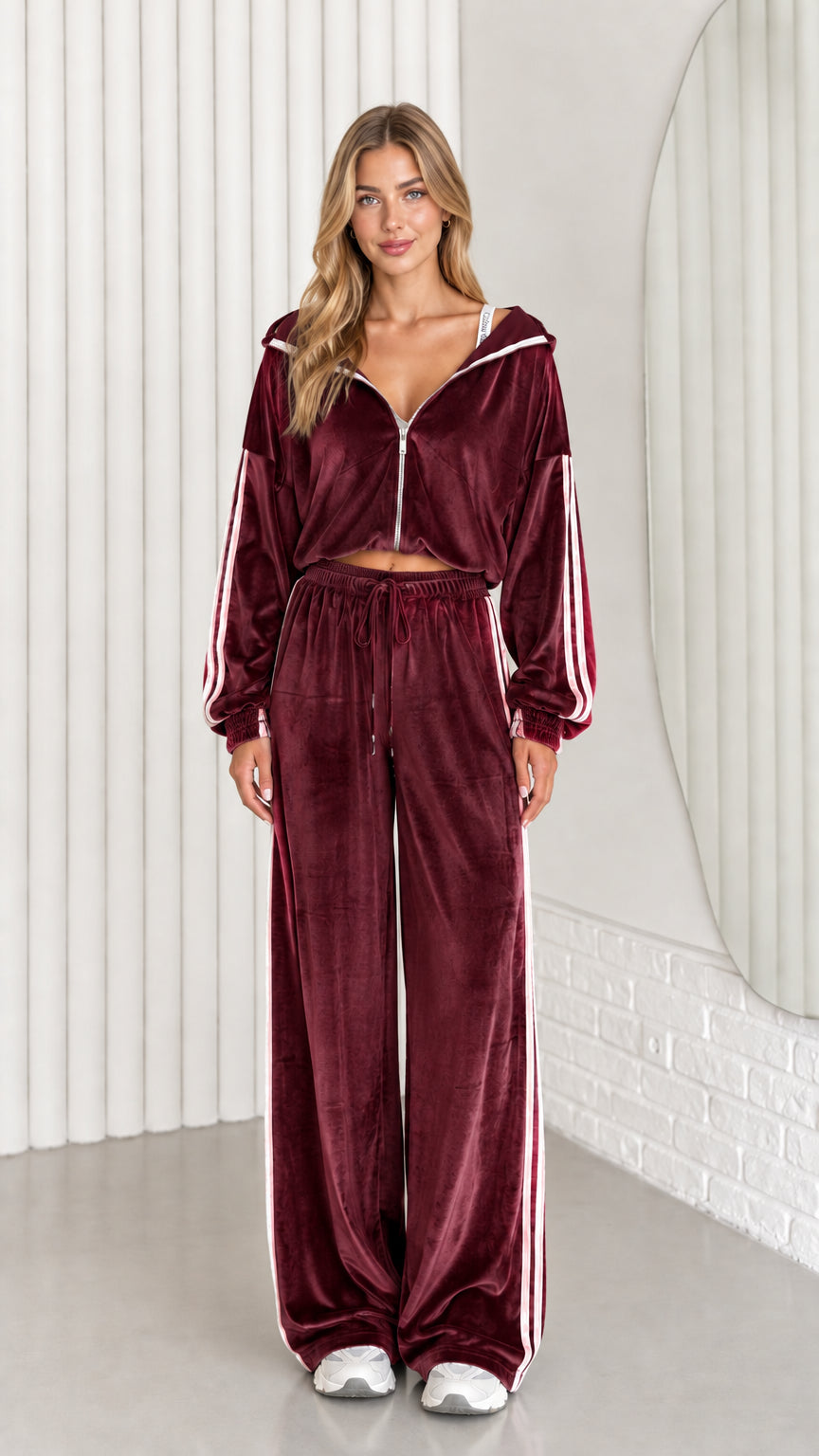 Front view of woman wearing burgundy velour cropped zip-up hoodie and wide leg pant set