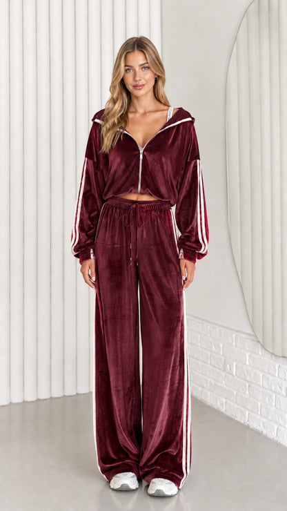Front view of woman wearing burgundy velour cropped zip-up hoodie and wide leg pant set