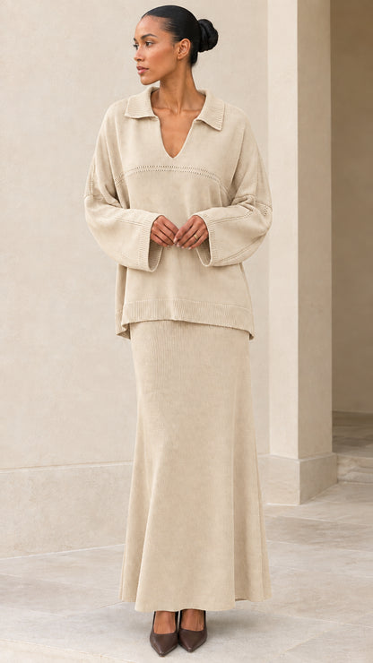 Front view of model wearing Beige oatmeal knit polo pullover and maxi skirt set