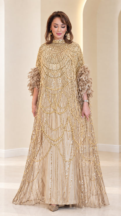 Champagne gold embellished cape maxi gown with feather trim